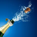 Photo of champagne popping.