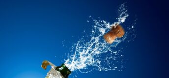 Photo of champagne popping.