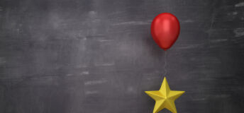Stars with red balloon lifting one against a chalkboard background